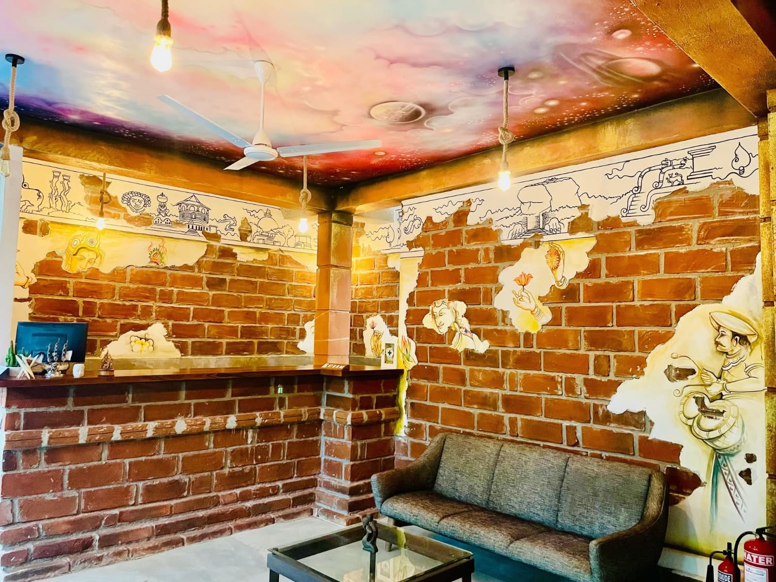 Reception lounge with traditional Sri Lankan murals and brick walls