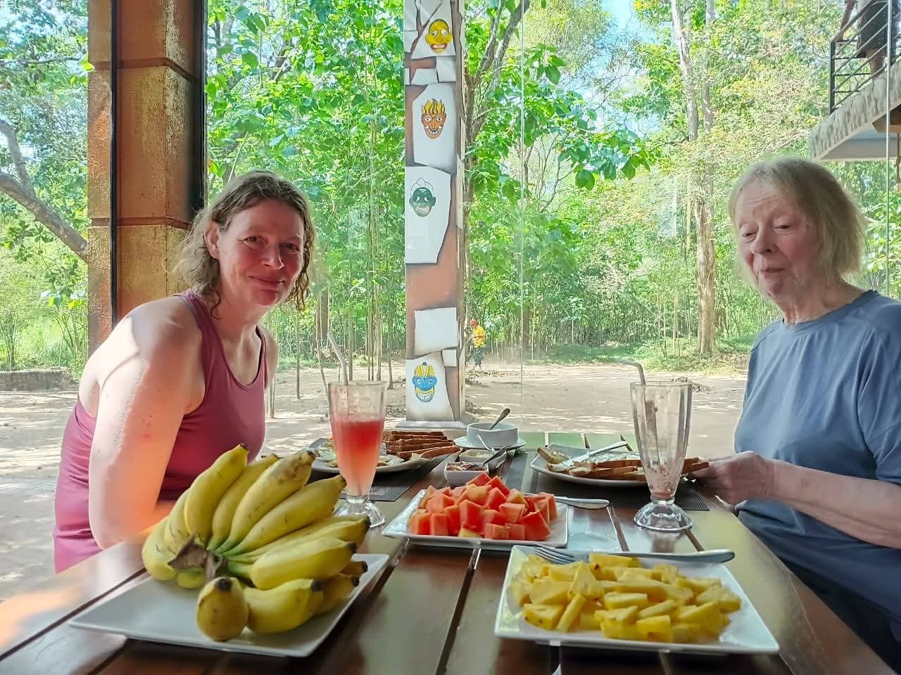 Open-air breakfast with tropical fruit overlooking the forest