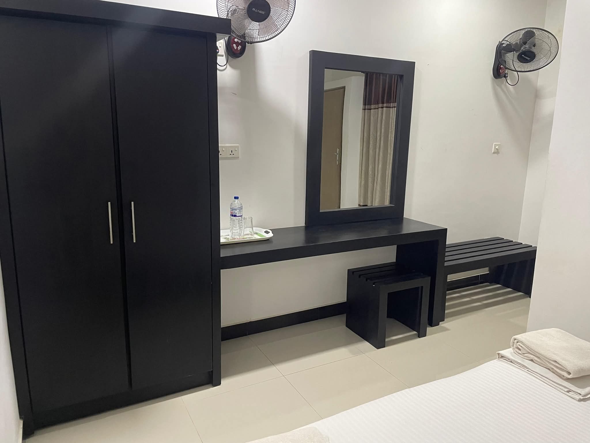 Spacious room with wardrobe, dressing table and mirror