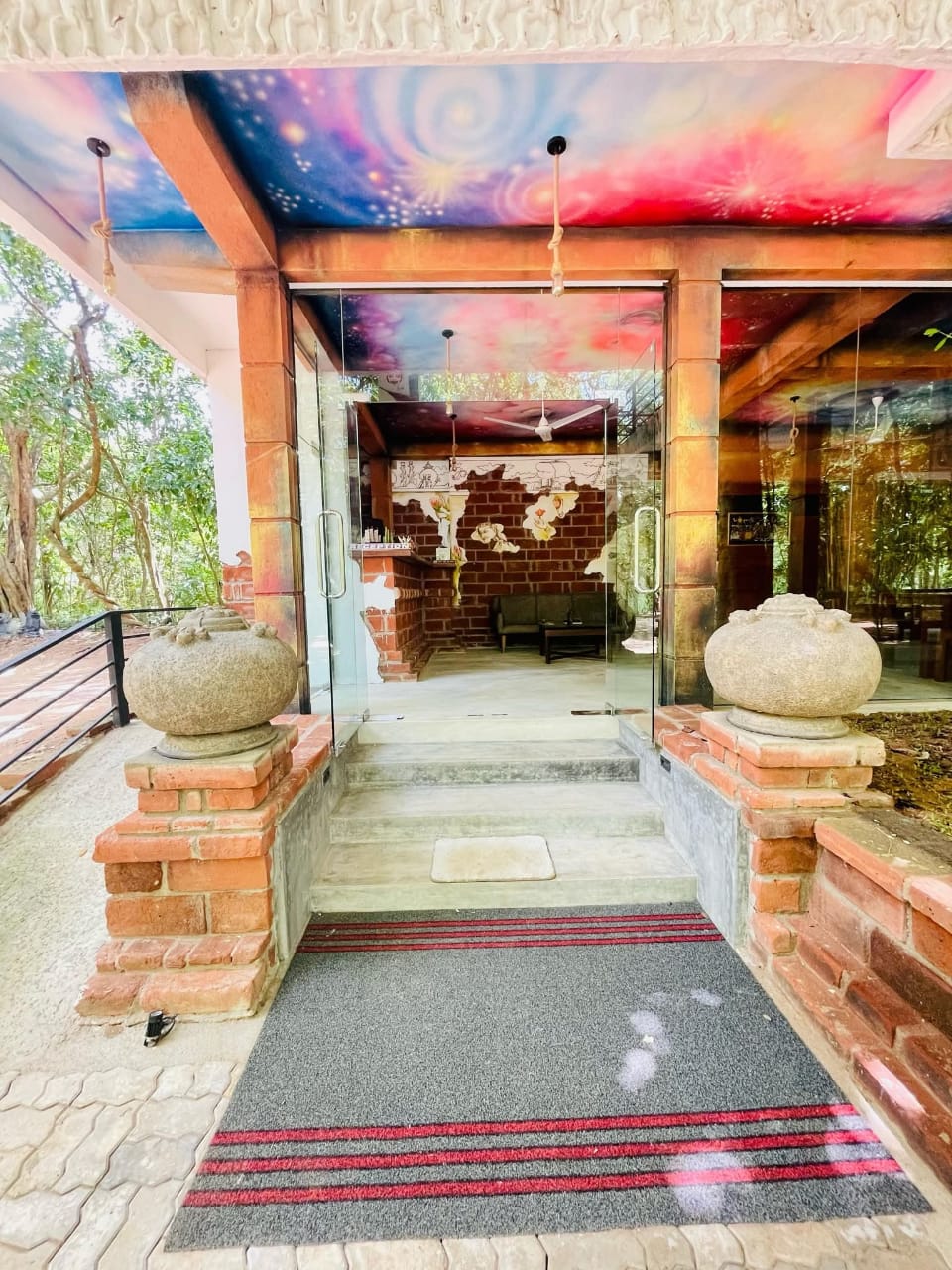 Entrance of Saliyawewa Cabins with hand-painted galaxy ceiling and glass doors
